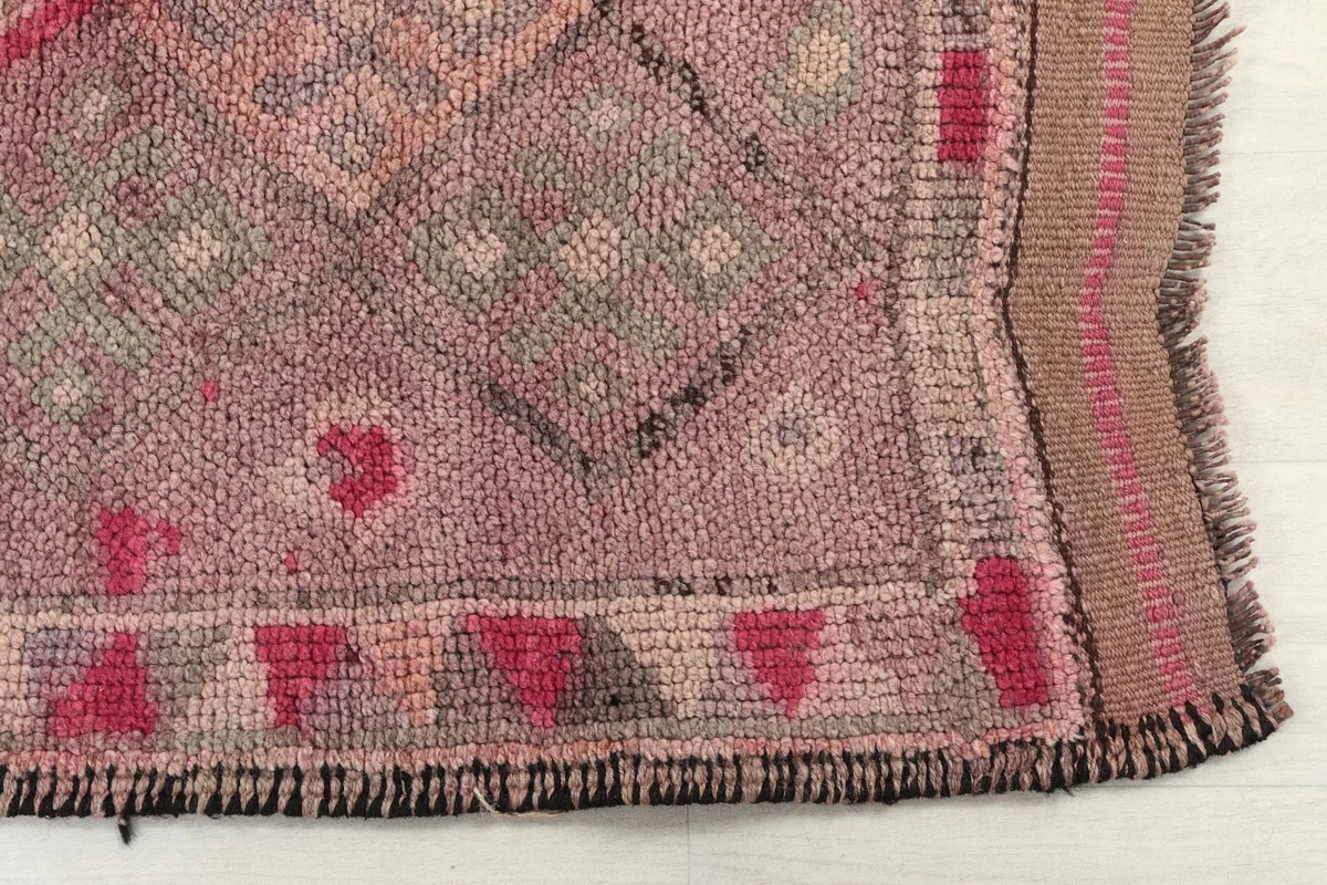 Detailed view of the runner's end, highlighting the subtle border and fringe