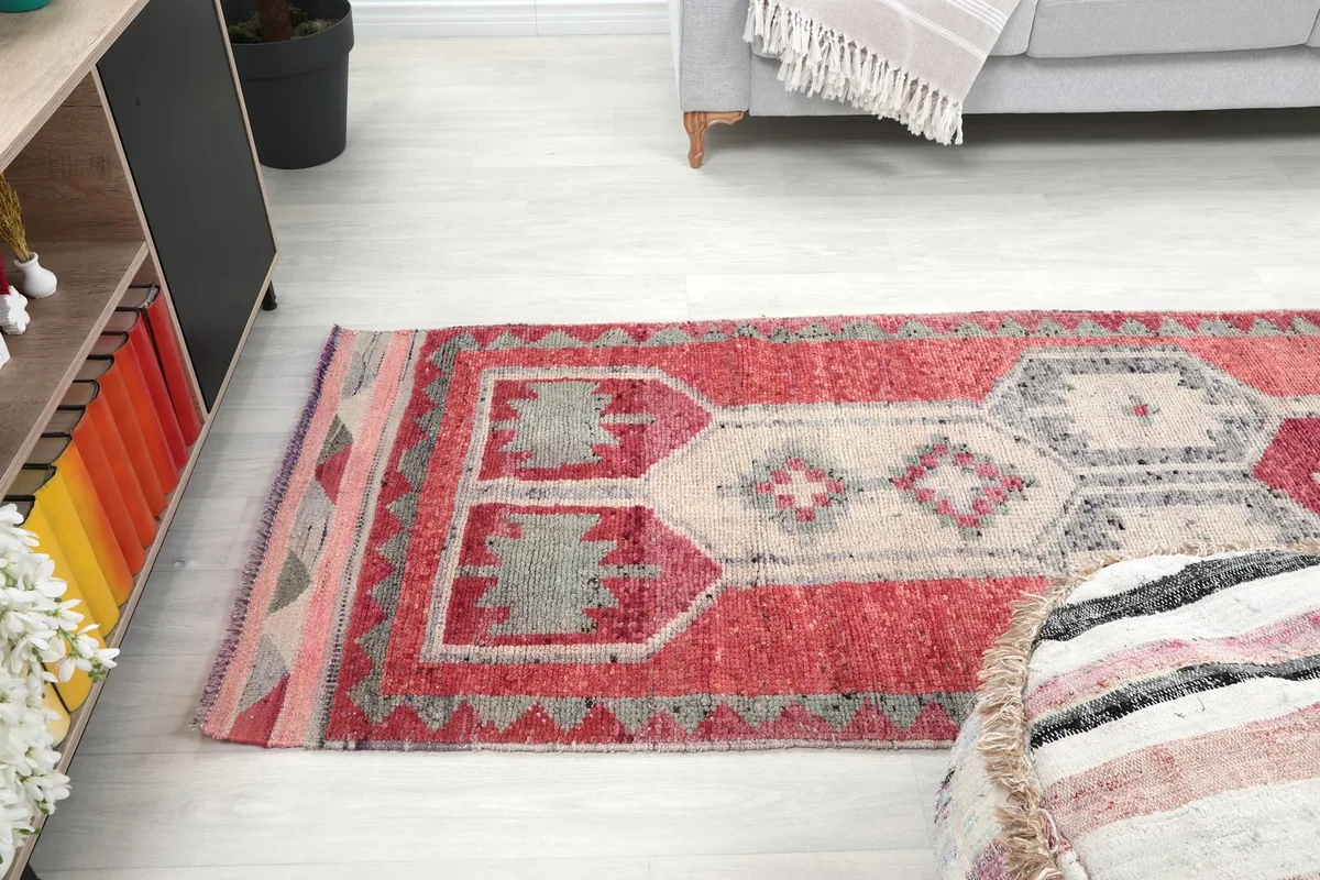 Runner rug extending through a hallway or living space from a side angle
