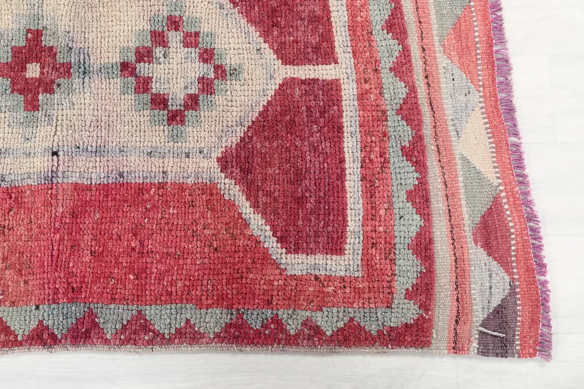 Detailed view of the rose field and geometric motifs with a gray border