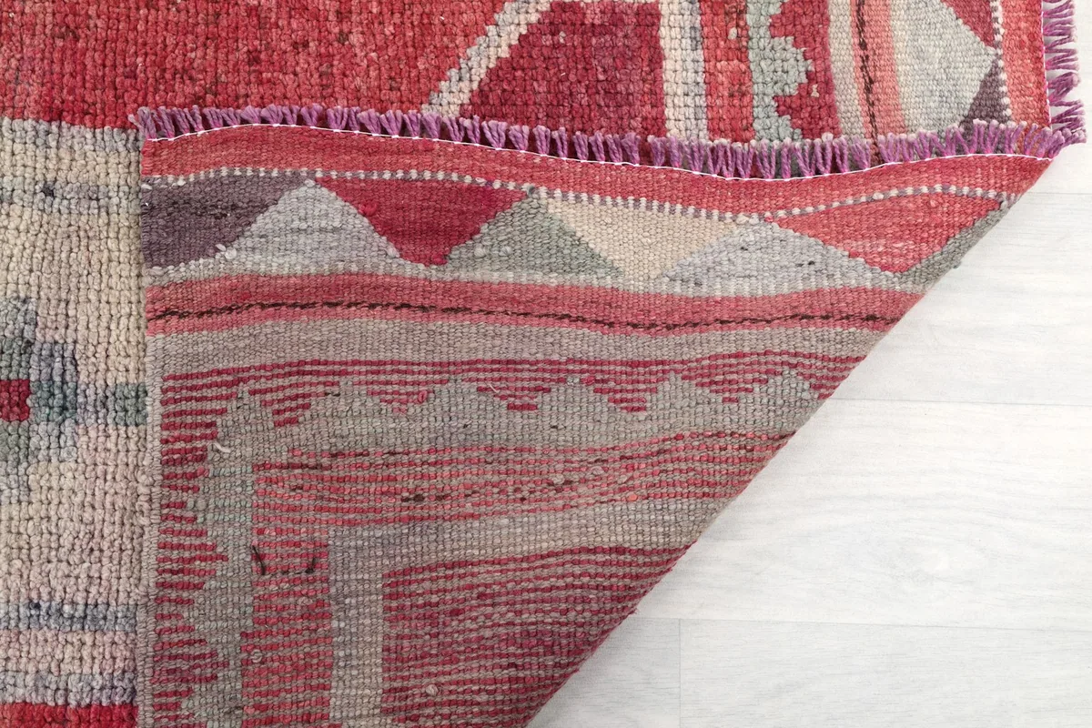 Detail of the rug's fringe and the reverse side, showing craftsmanship
