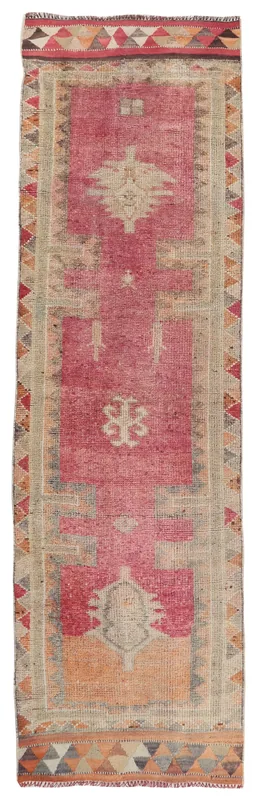 Full overhead view of the rose and beige geometric vintage runner rug