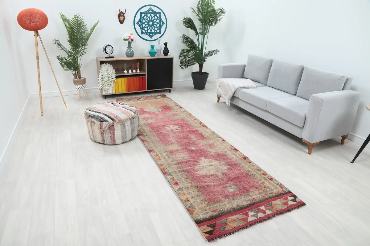 Overhead angle of the rose runner rug in a room setting, showing its length