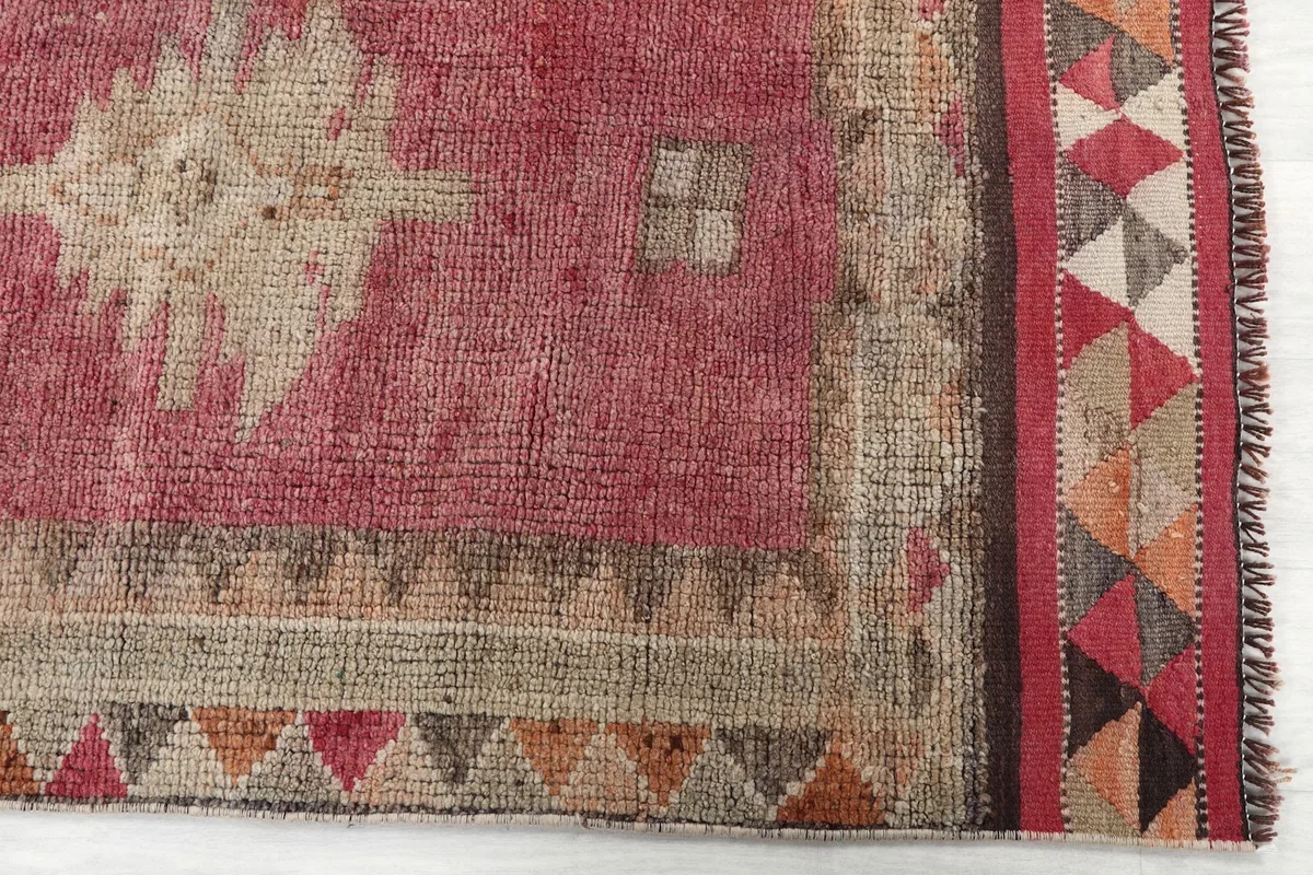 Detailed view of the geometric patterns and border design on the vintage runner