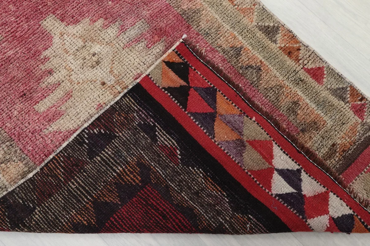 Underside view of the rug, revealing the cotton foundation and hand-knotted construction