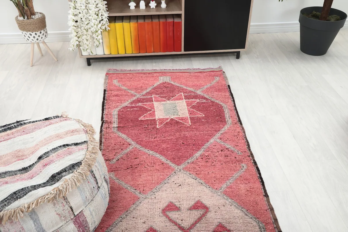 Partial view of the rose runner rug in a room, highlighting the top section of the design