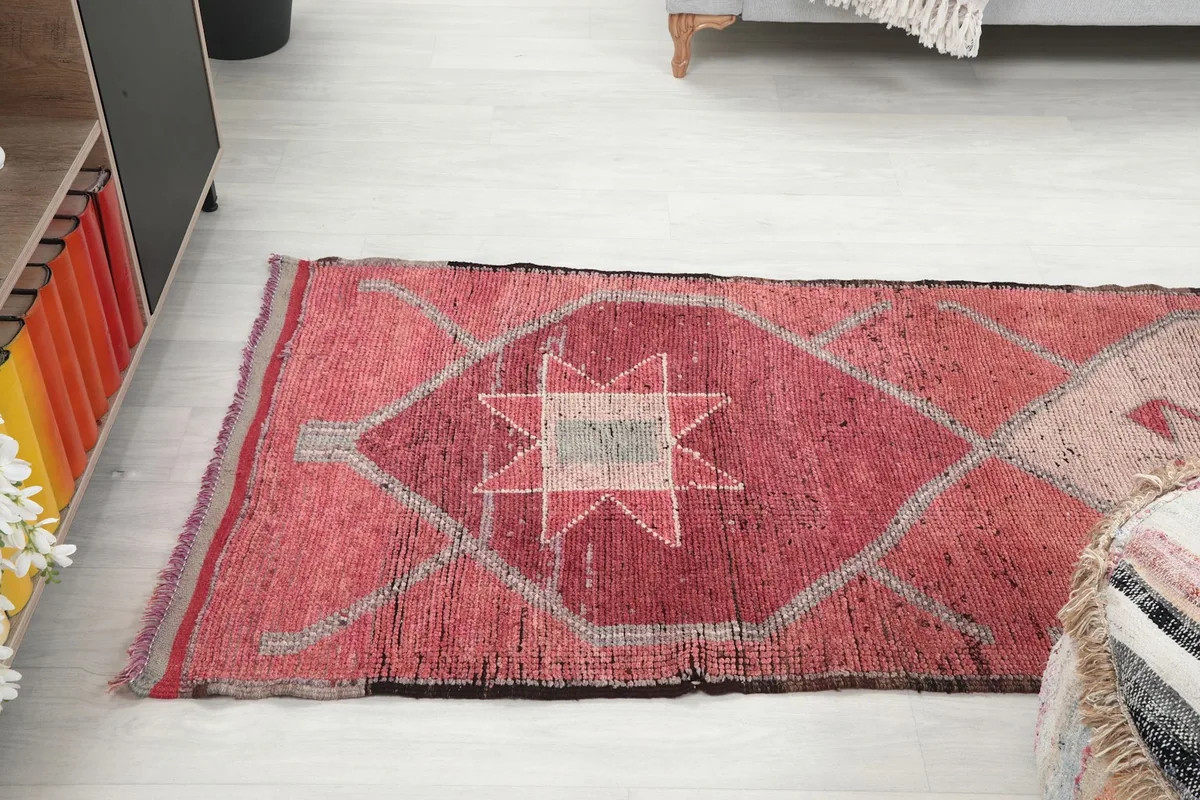 View of the lower section of the rose runner rug in a room, showcasing a star motif