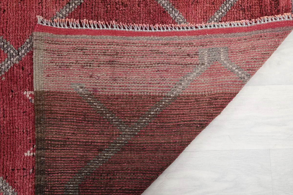 Close-up of the back of the rose runner rug, revealing the tight knotting