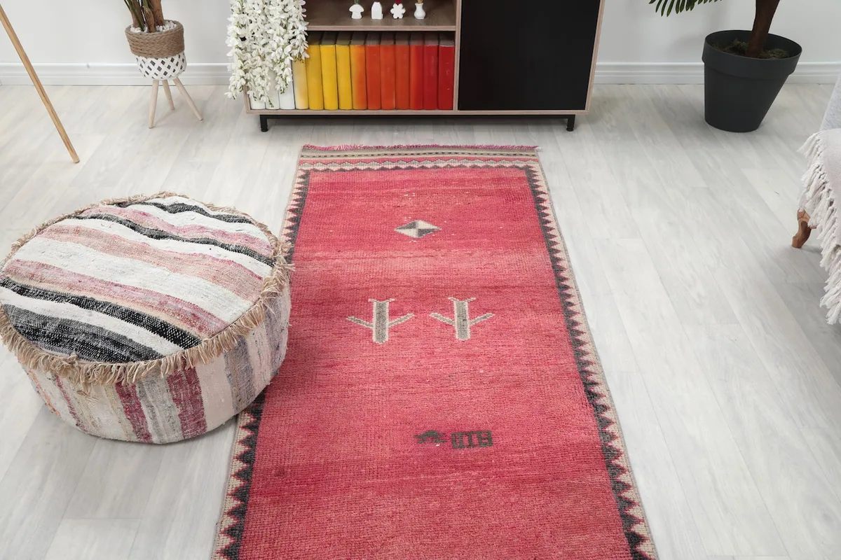 Overhead angle view of the runner rug, showcasing the spacing of the tribal motifs along its length.