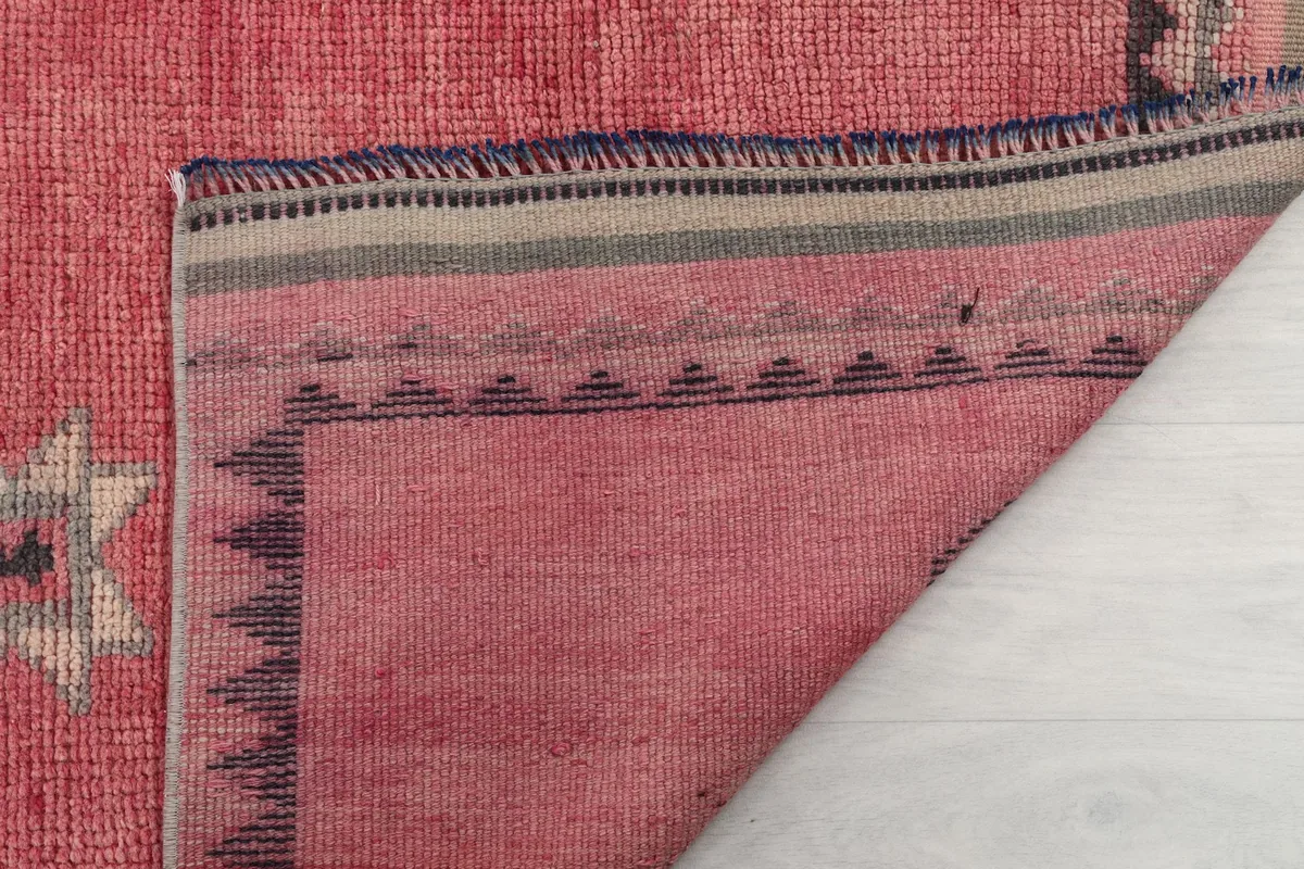 Underside of the rug showing the tight weave of the cotton foundation and the back of the wool pile.
