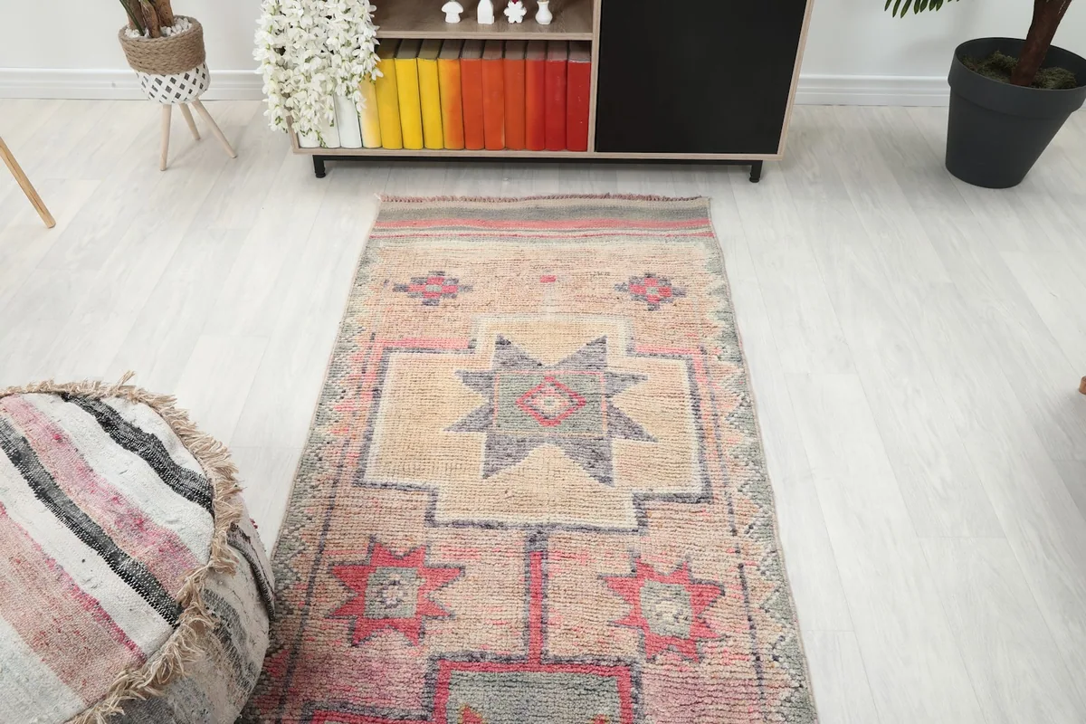 Overhead view of the runner rug in a room, focusing on the beige field and geometric patterns