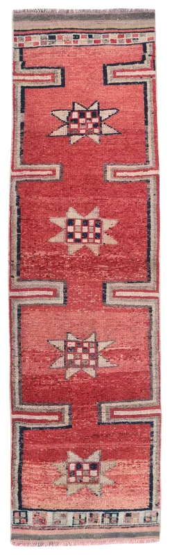 Full top view of the vintage red geometric Anatolian runner rug on a white background