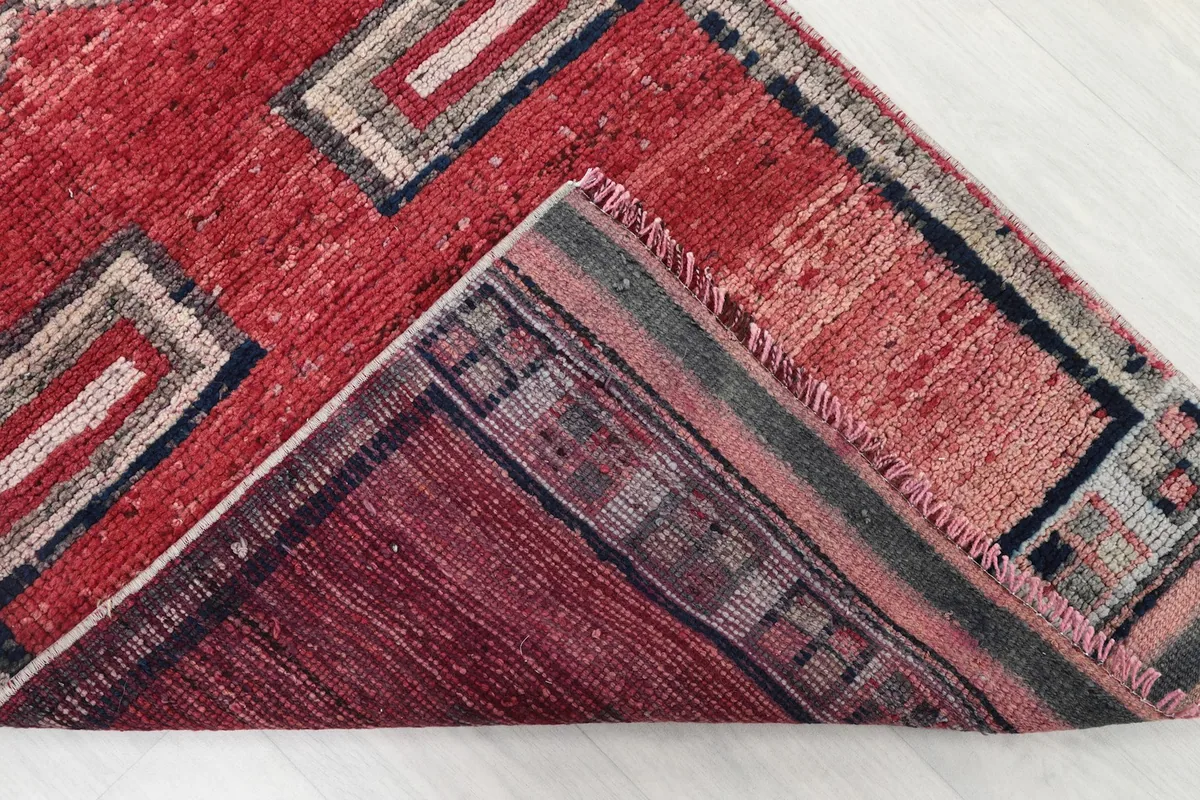 Corner view showing the reverse side of the hand-knotted wool pile on cotton foundation