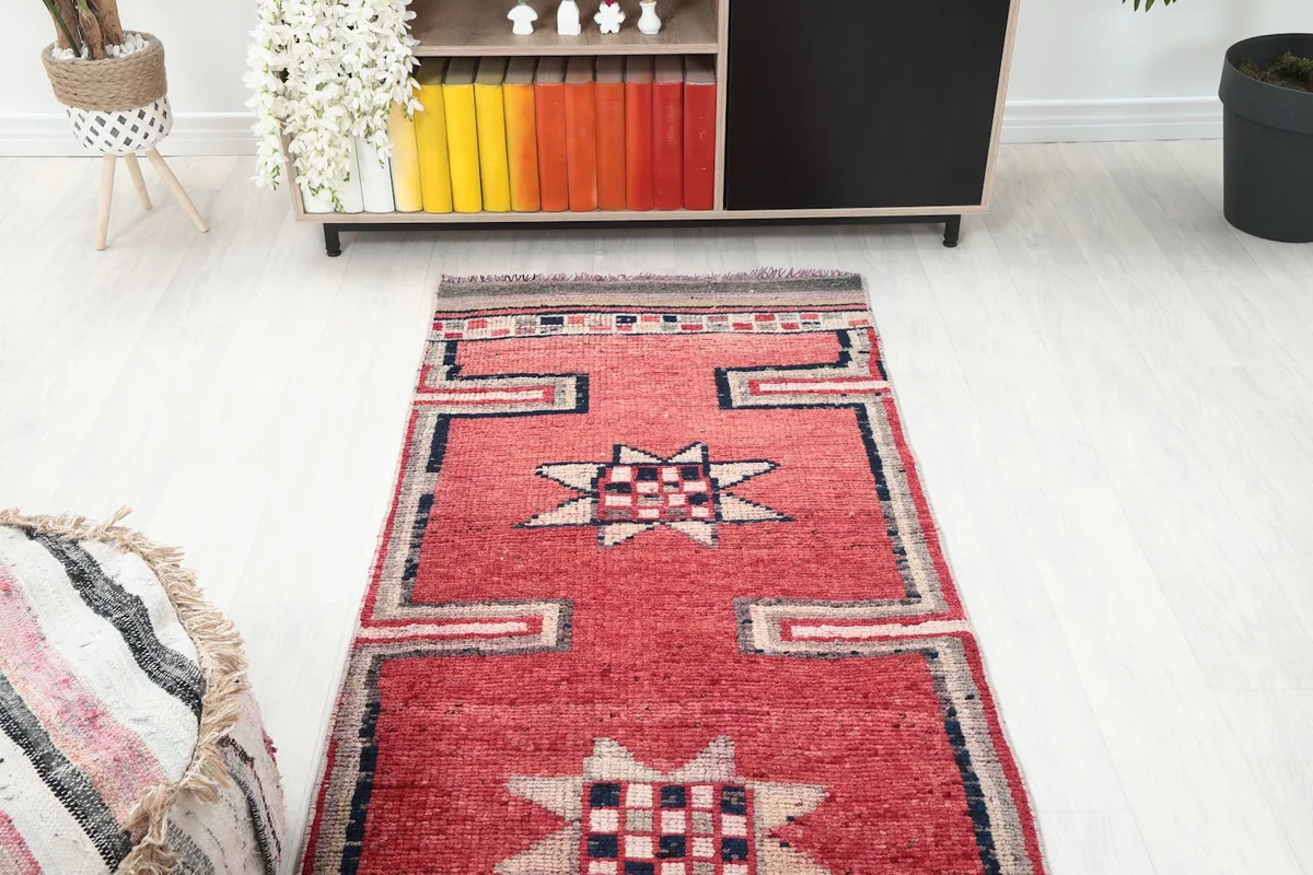 Overhead view of a section of the red runner rug, showing the geometric pattern repeat
