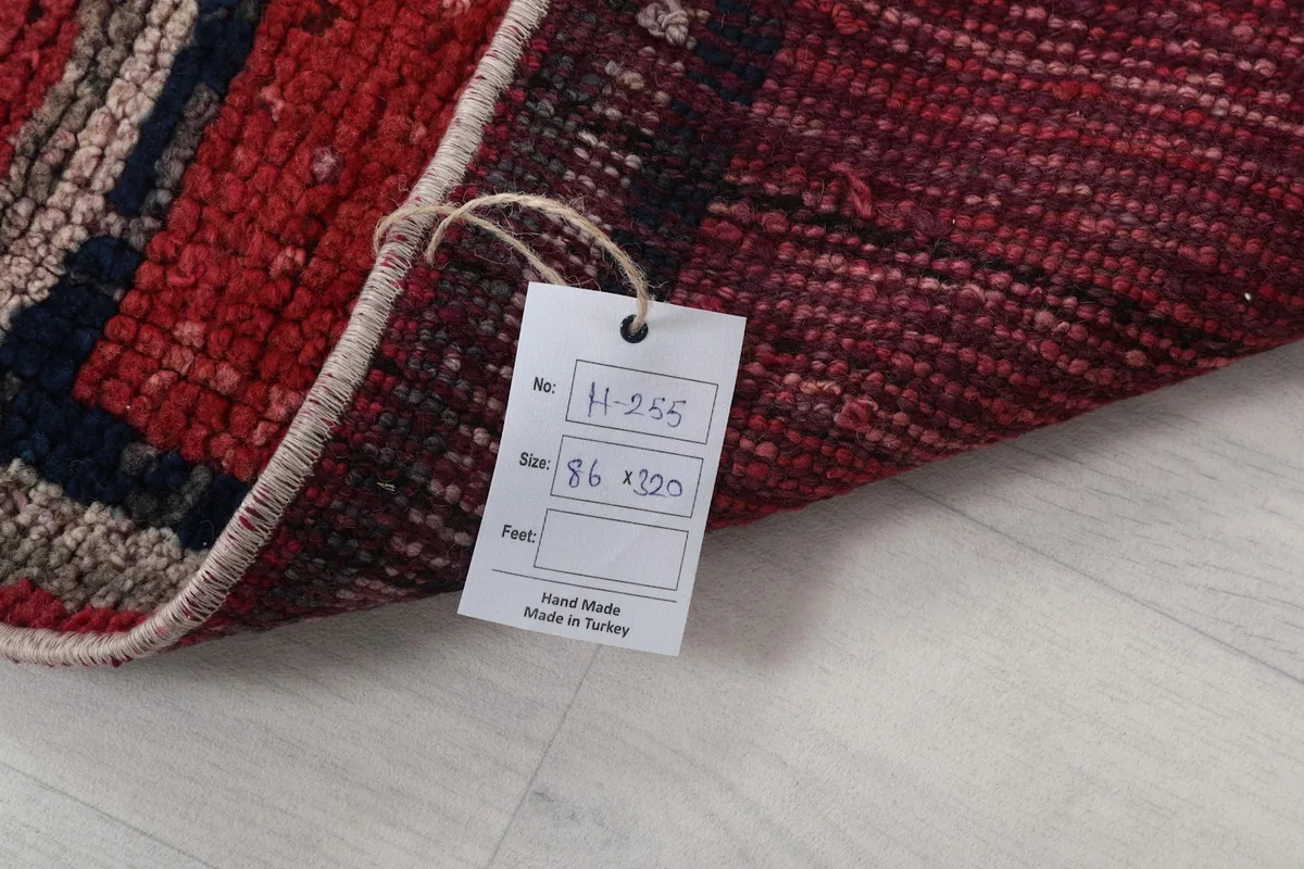 Corner of the rug with a tag showing its size and origin as hand-made in Turkey