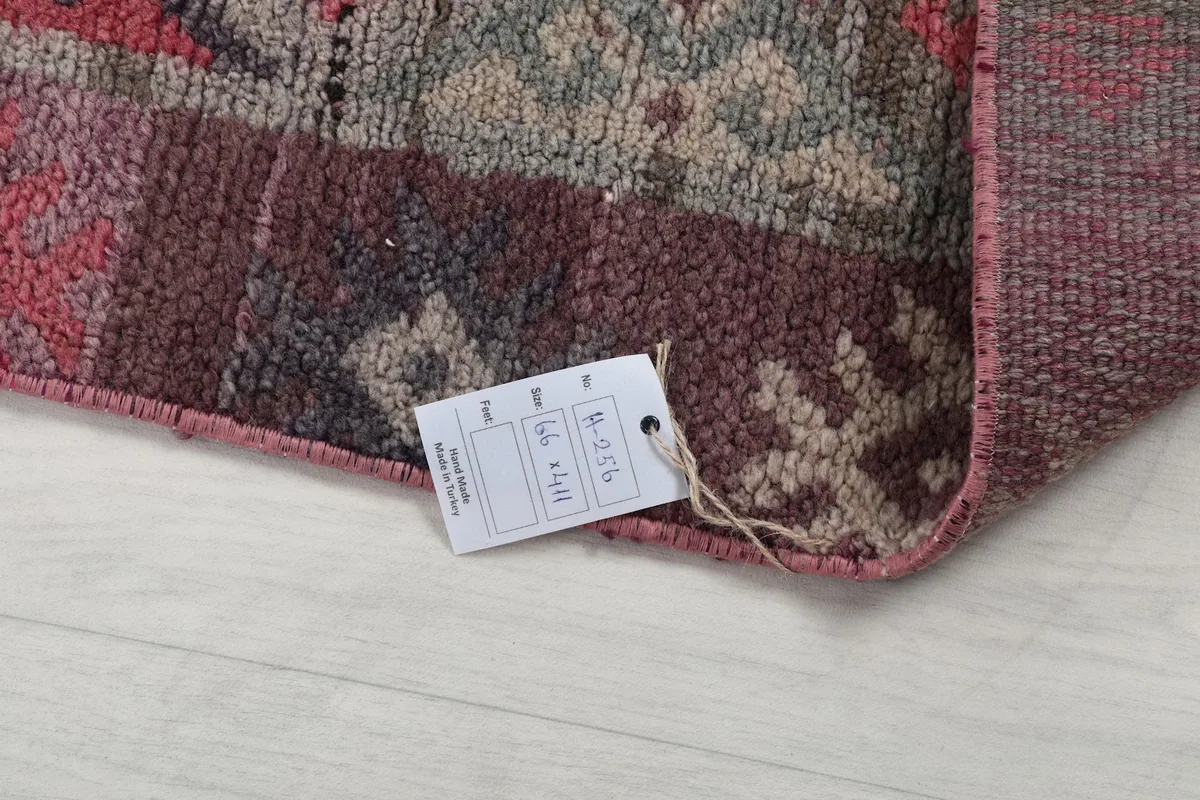 Corner of the rug with the product tag attached, displaying its authenticity and details.