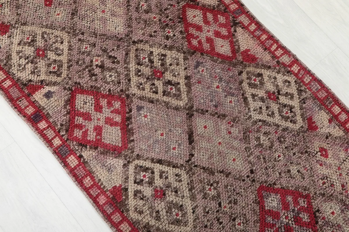 Close-up of the geometric and tribal patterns on the vintage Anatolian runner rug