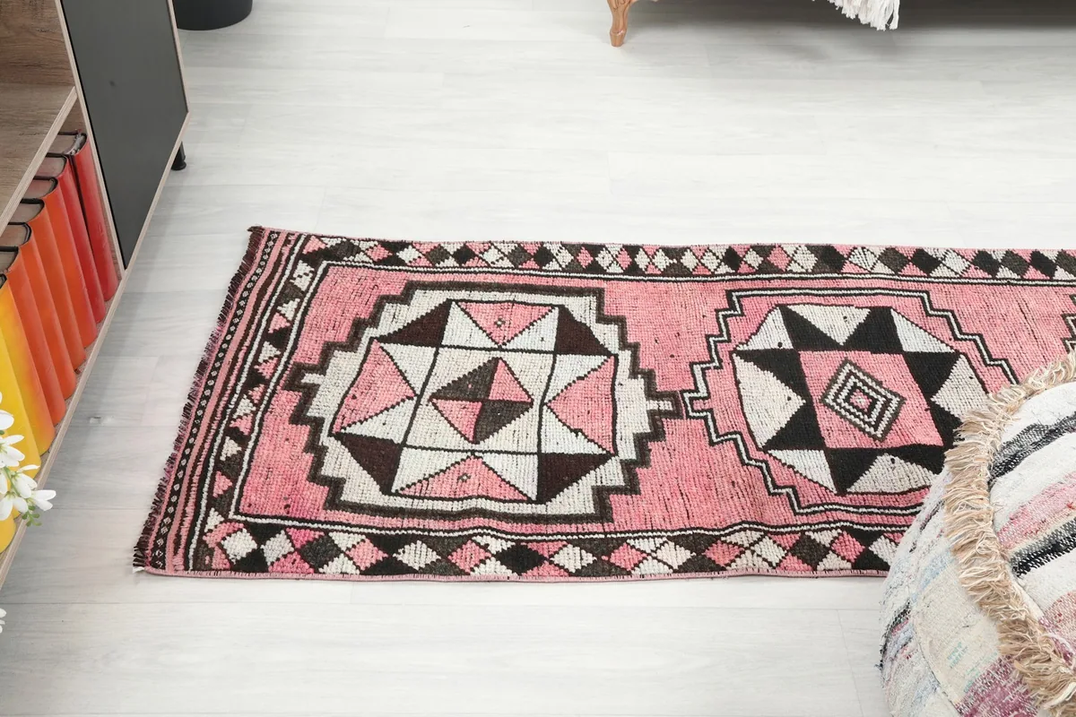 View of the runner rug stretching across a room, from a slightly elevated perspective