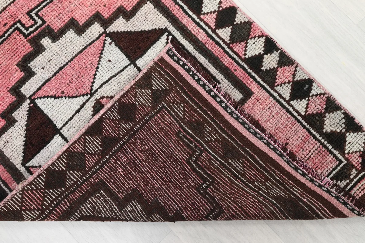 View of the back of the hand-knotted wool rug, showing the cotton foundation and weave