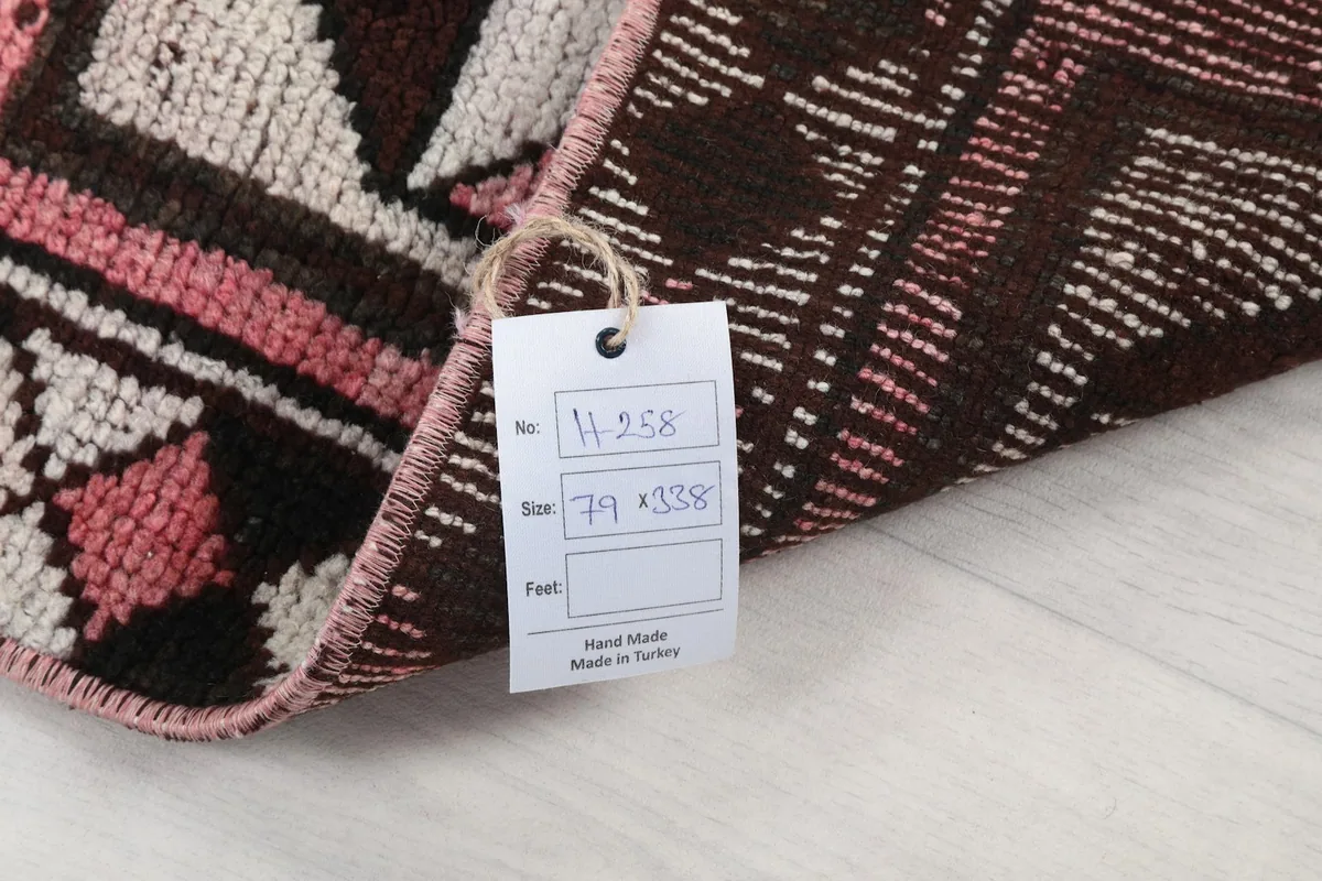 Close-up of the rug's back with a tag showing its dimensions and origin