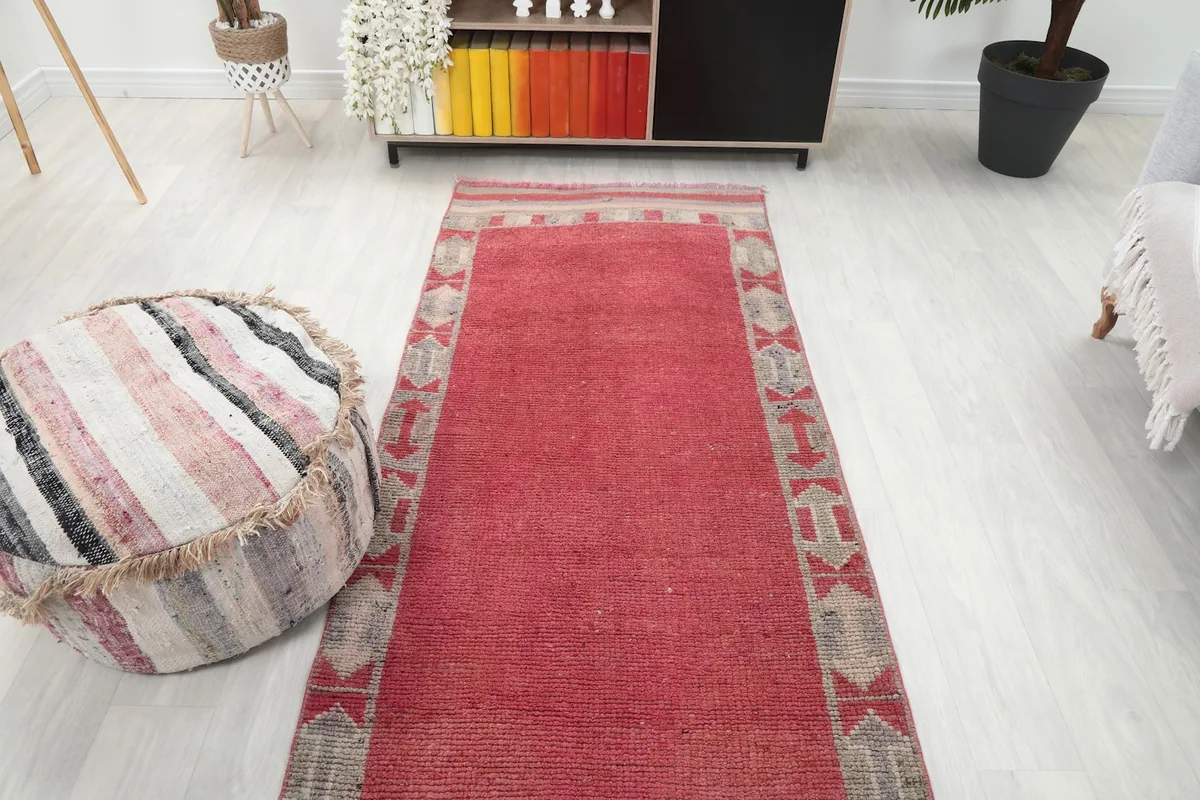 Overhead view of the runner in a room, showcasing its full length and the consistent geometric border design.