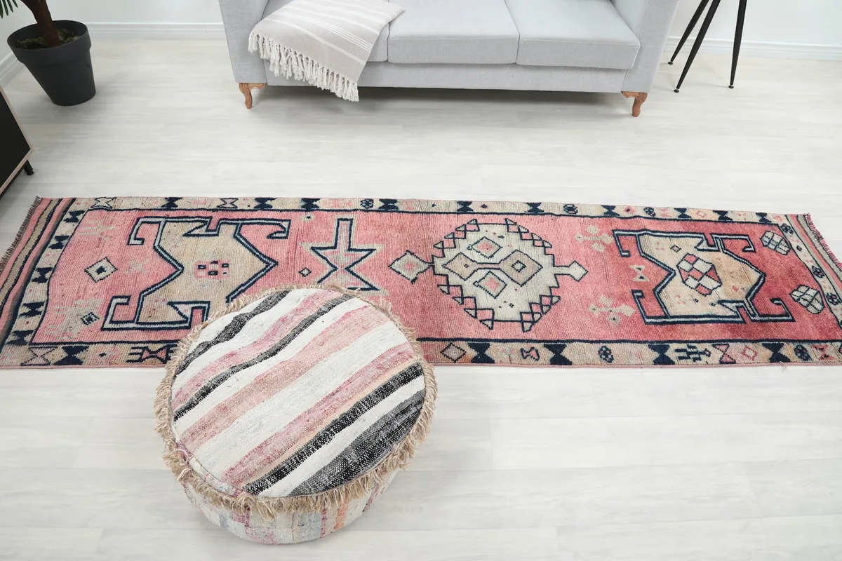 Long shot of the runner rug in a room with a sofa, showcasing its scale and placement