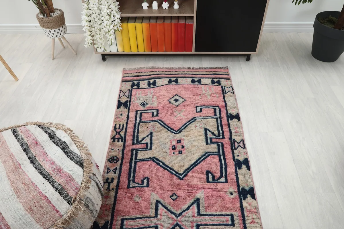 Overhead view of the runner rug from one end, showing the patterned field and border