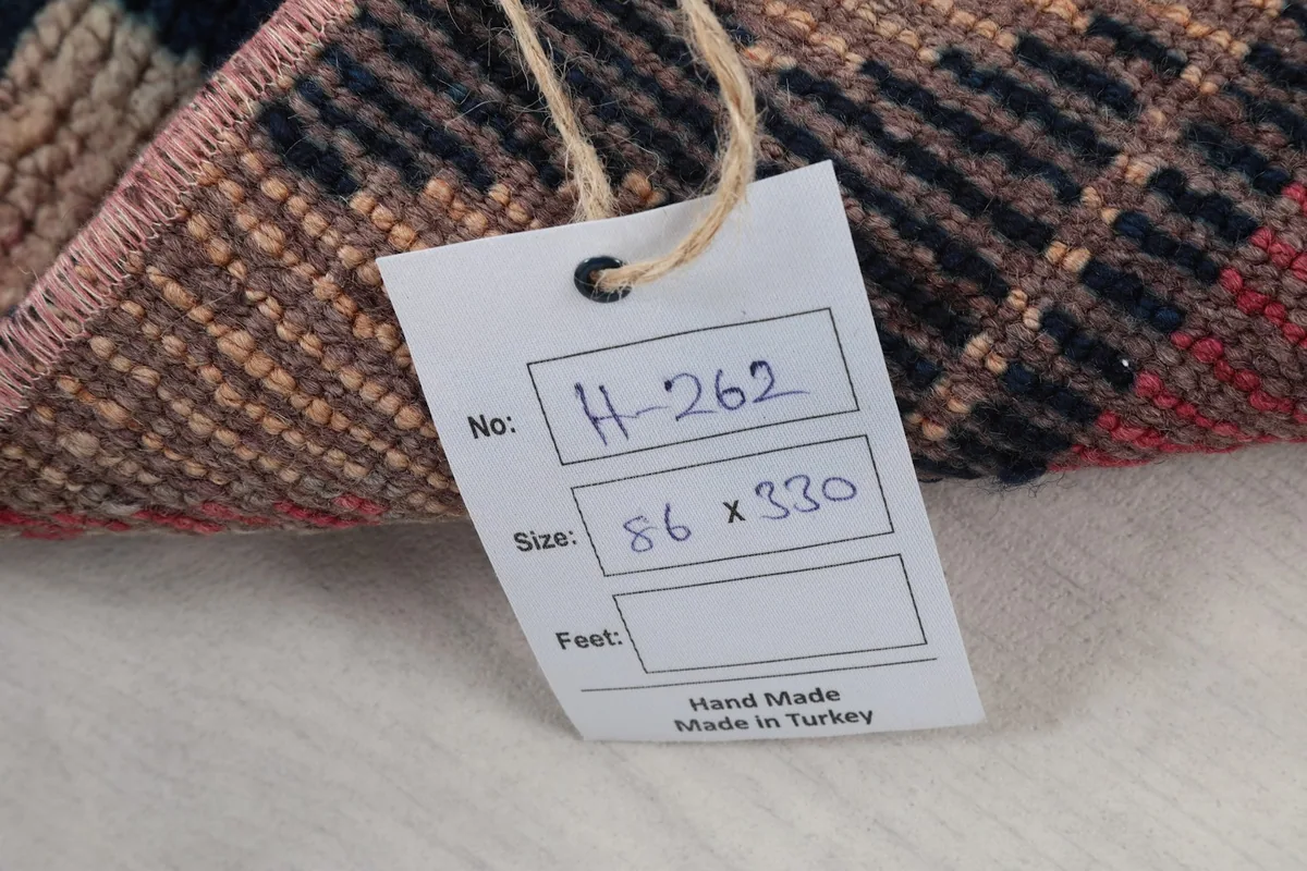 Tag showing the rug's product number H-262 and dimensions 86 x 330 cm, made in Turkey