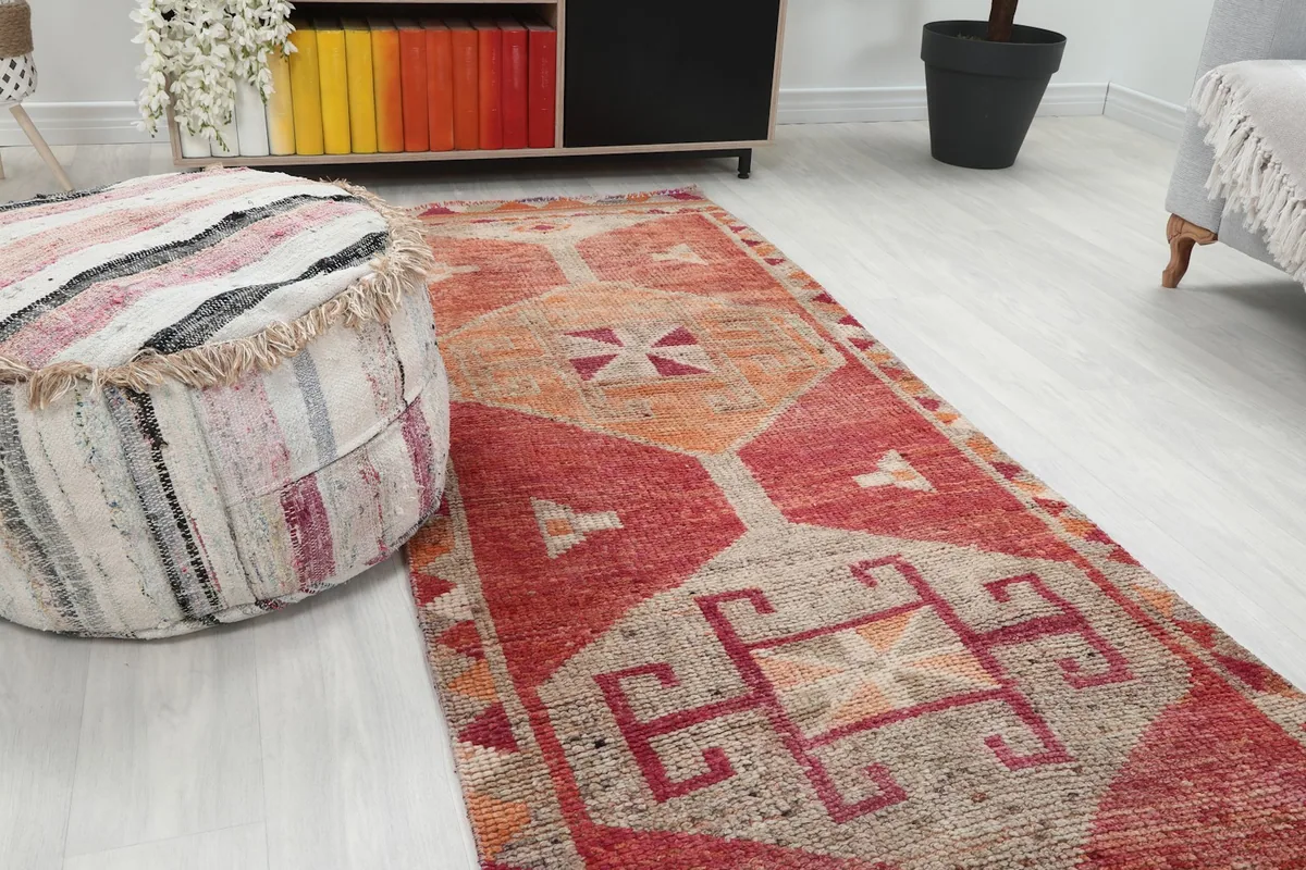 Close-up angled view of the geometric patterns and colors of the rug