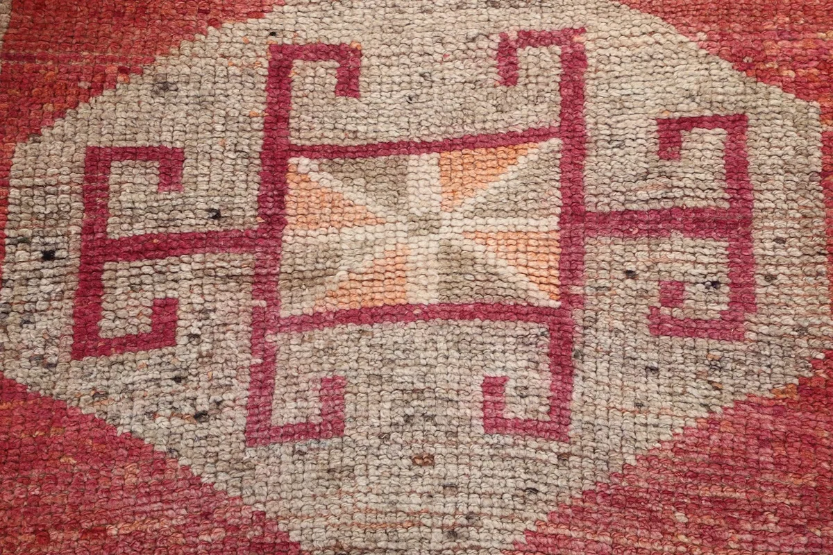 Very close detail of the hand-knotted wool pile and tribal pattern