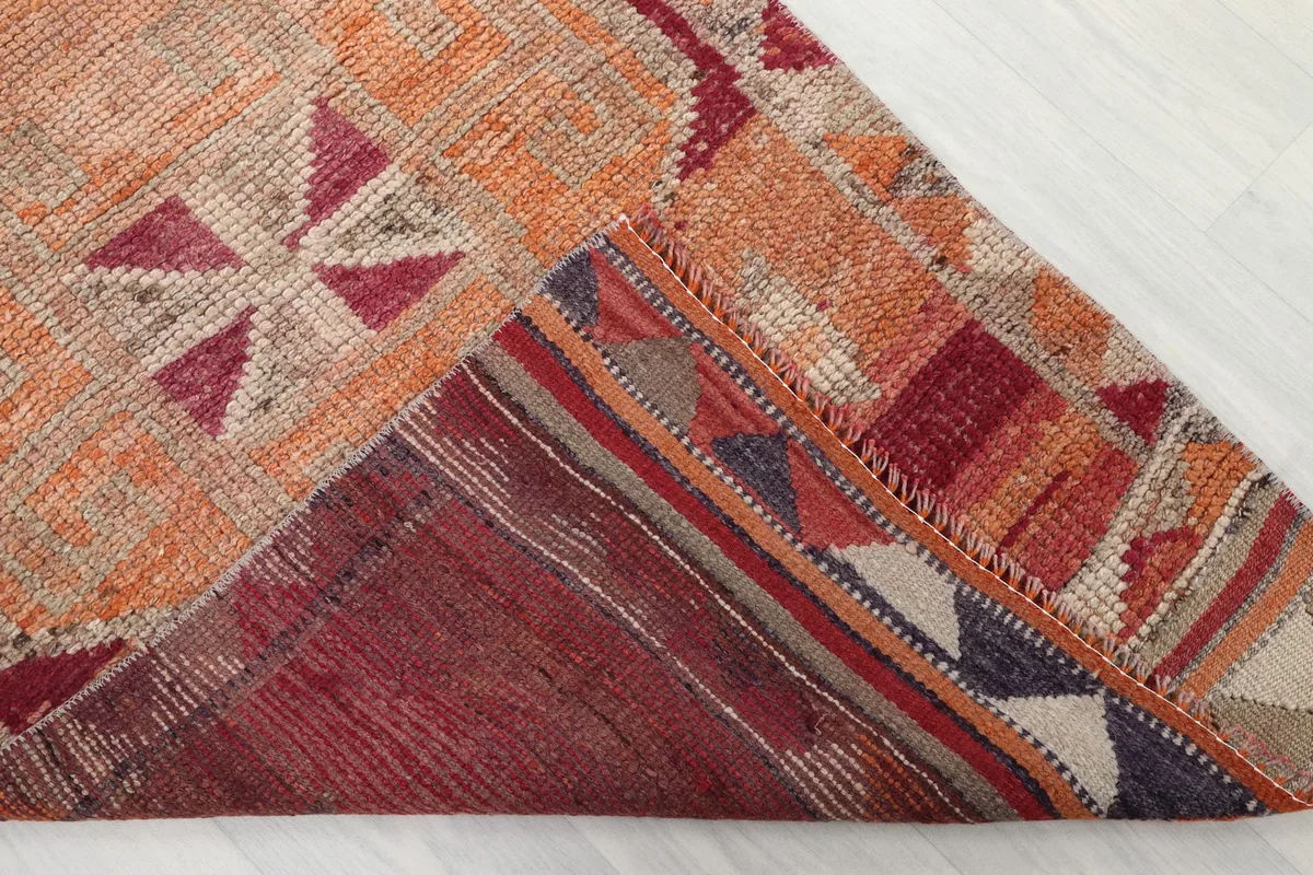Underside of the rug showing the cotton foundation and reverse of the knots