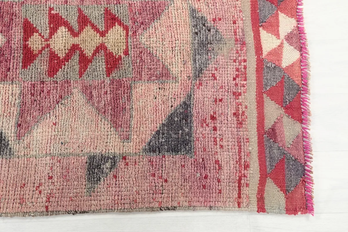 Detailed shot of a section of the runner, showing the red, pink, ivory, and gray colors