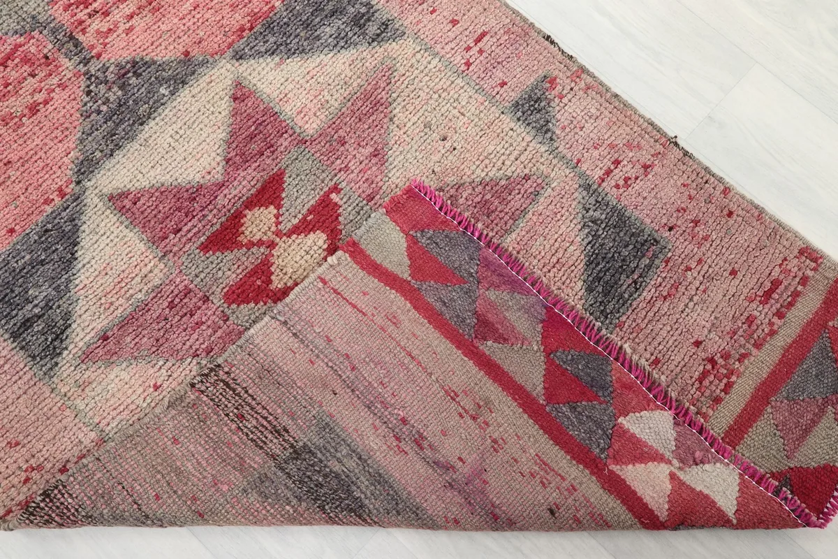 Corner of the runner folded to show the cotton foundation and reverse side of the knotting