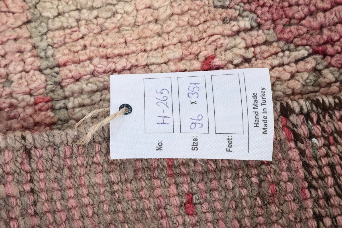 Close-up of the rug's label displaying the dimensions and origin details