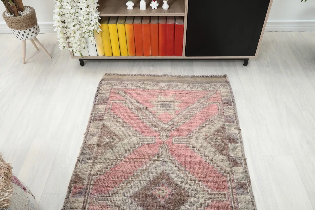 Overhead view of the vintage runner rug in a room, showcasing its full length and geometric design from above.