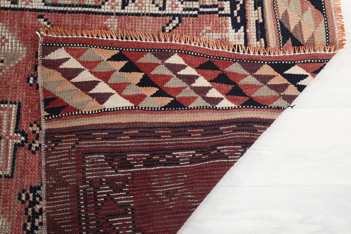 Close-up of the rug's backing and fringe, showing the quality of craftsmanship