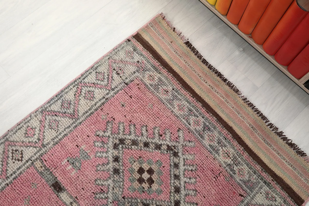 Corner view of the runner rug, showcasing the border design and part of the main field
