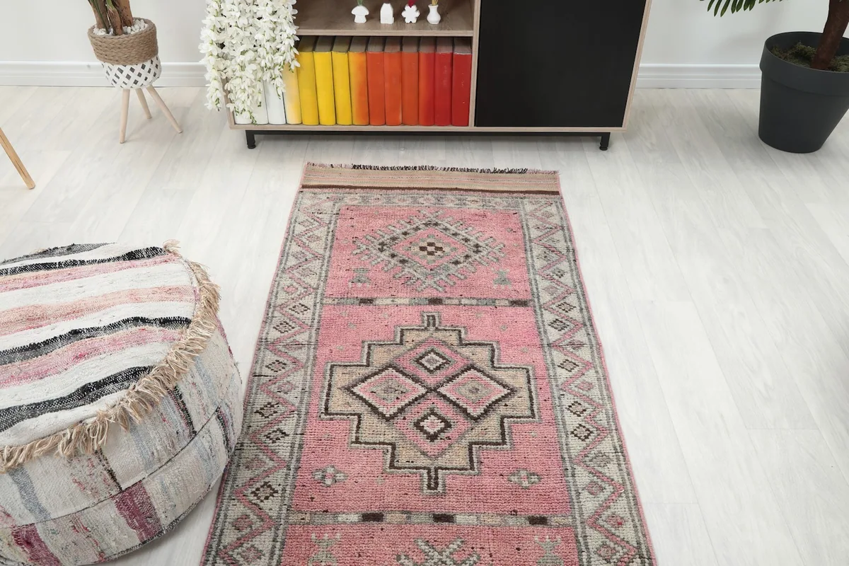 Overhead view of the rose runner rug in a room, showing its full length and design