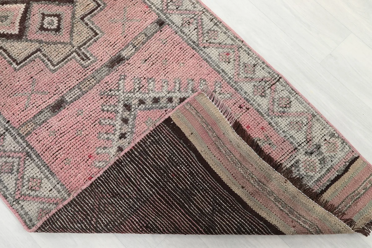 View of the back of the hand-knotted wool runner rug, showing the cotton foundation