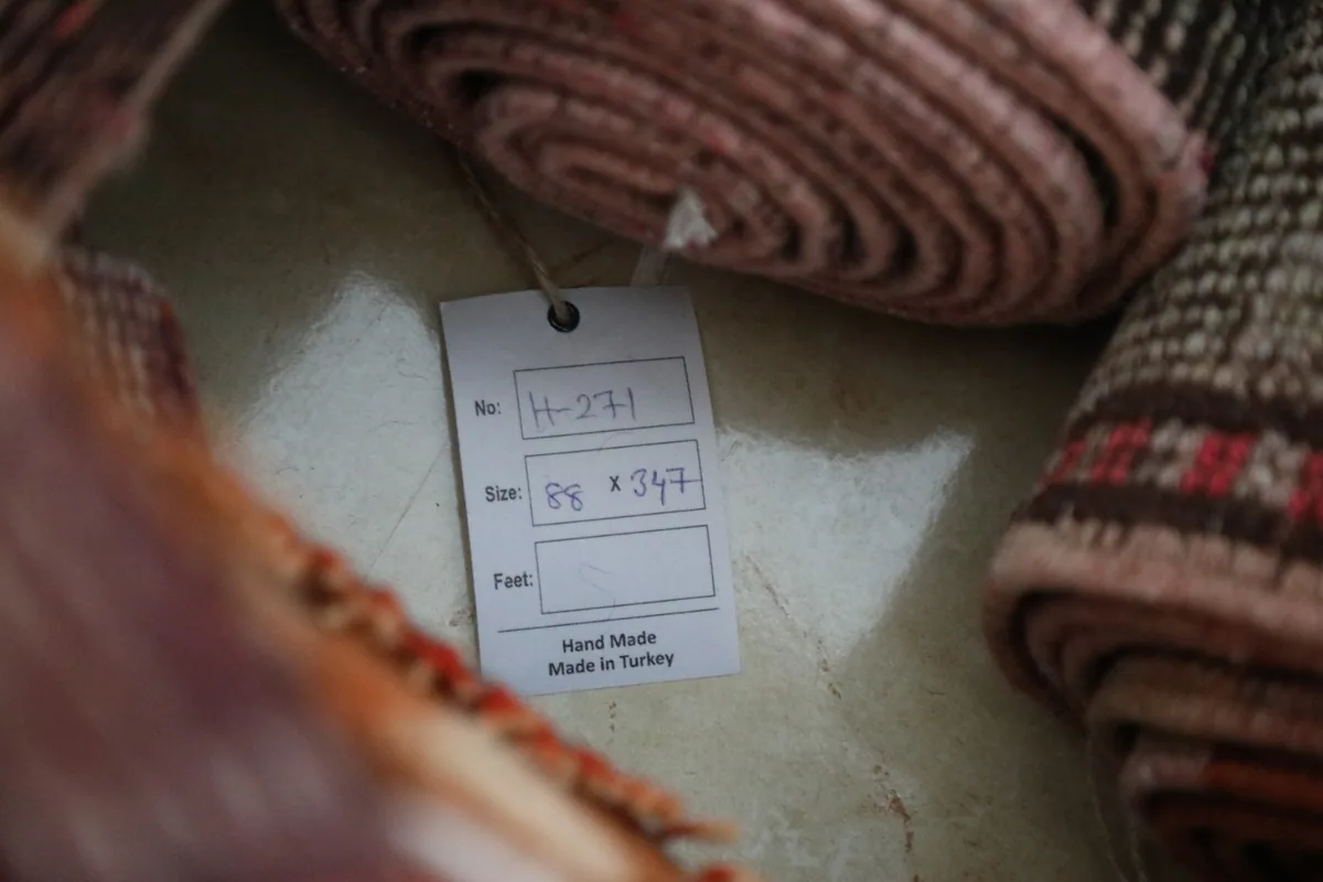 Product tag showing the dimensions and origin of the vintage Anatolian runner rug