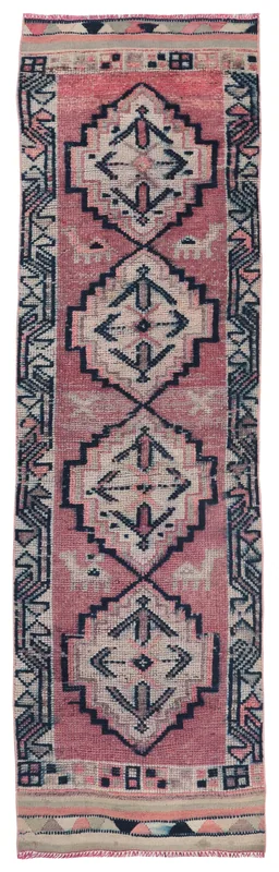 Full overhead view of the rose and navy geometric Anatolian runner rug on a white background
