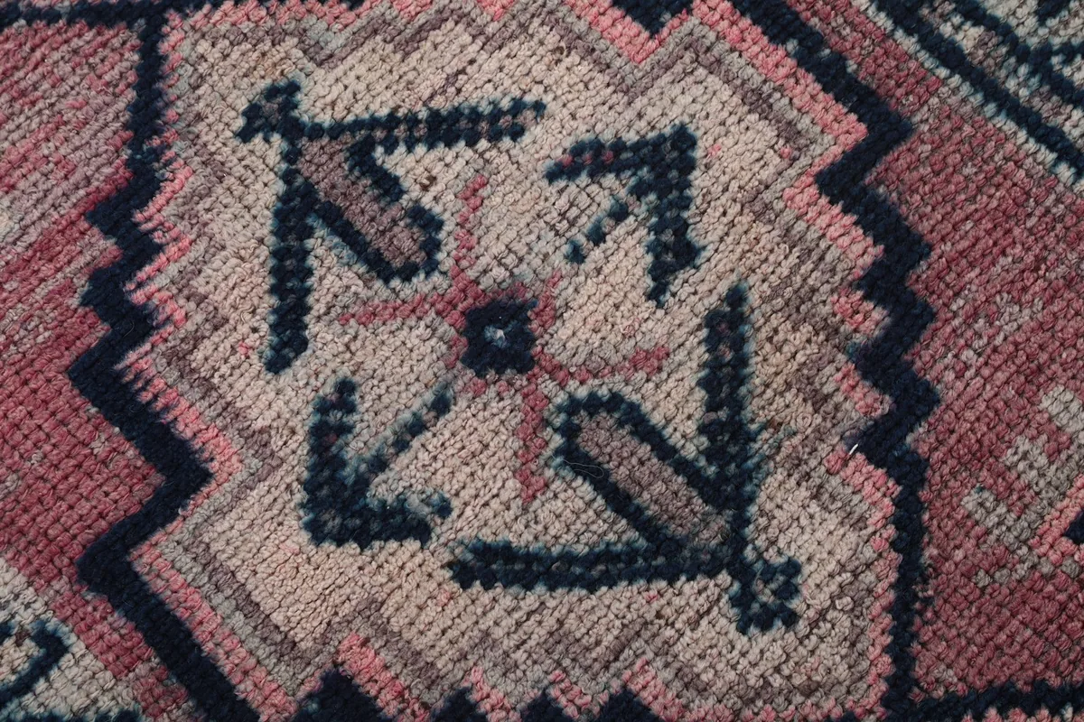 Extremely close-up shot of the wool pile texture and knotting detail of the rug