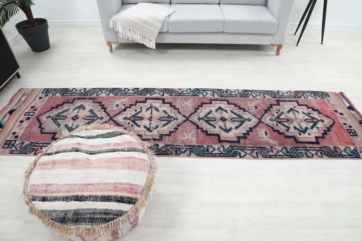Overhead view of the full runner rug in a room, highlighting its long, narrow shape