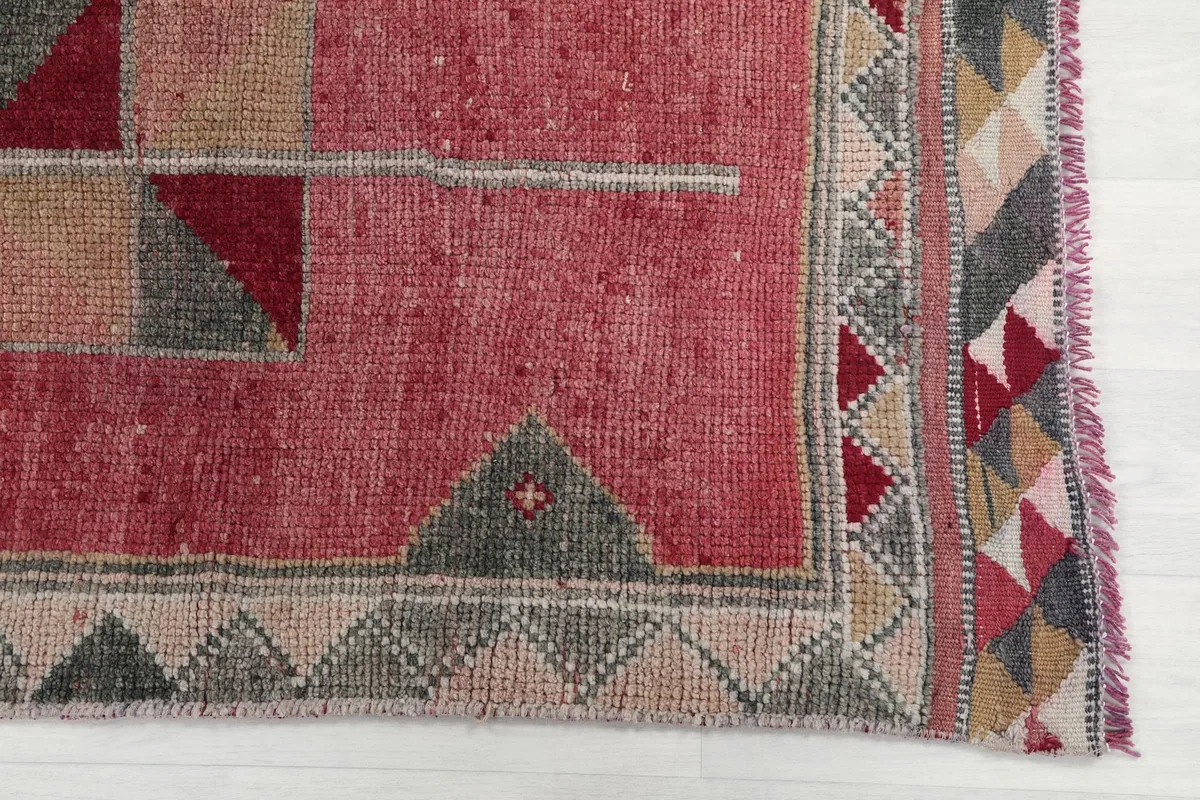 Detailed view of the rug's end, showing the border pattern and fringe.