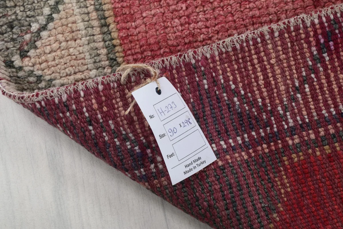 Close-up of the rug's reverse side with the product tag showing size and origin.