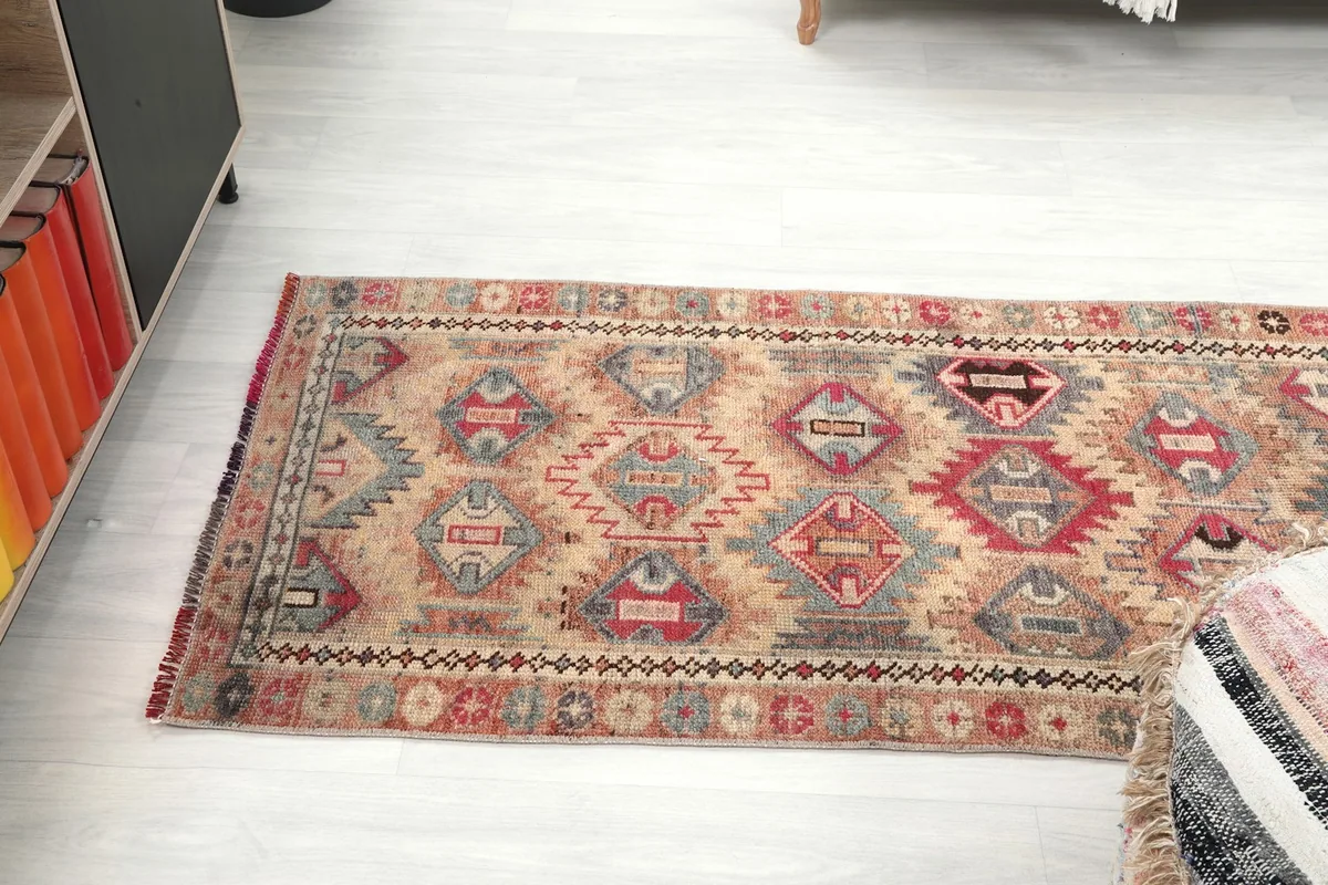 Full length view of the runner on a light floor, from a lower angle