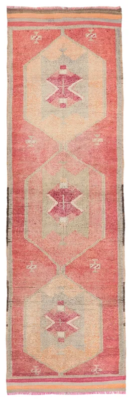 Full top view of a vintage rose and beige Anatolian runner rug with geometric tribal patterns