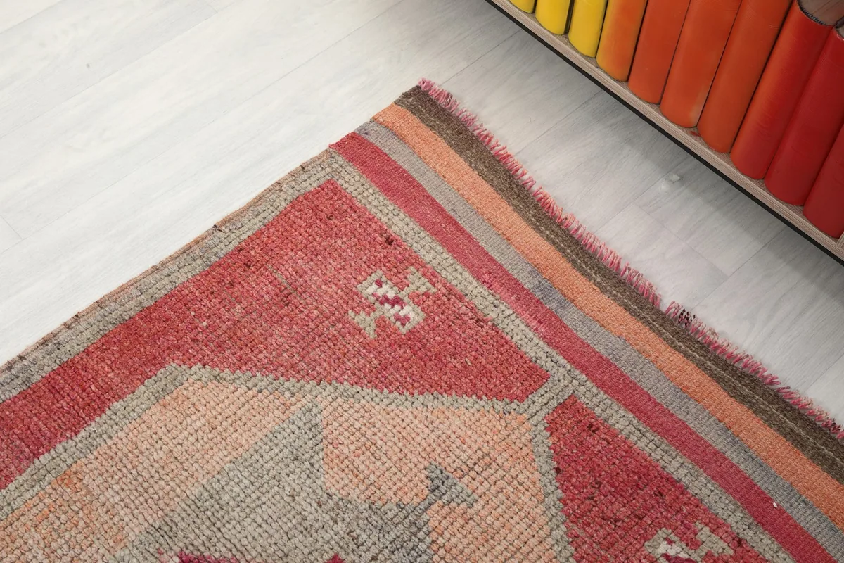 Corner detail of the runner rug, showing the border design and fringe