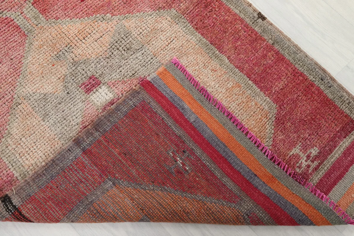 Underside of the rug, showing the cotton foundation and hand-knotted construction