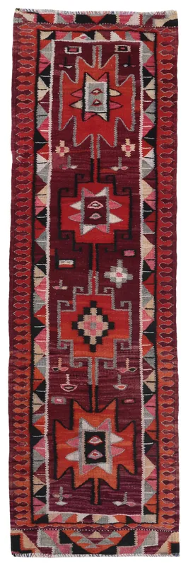 Full top view of the vintage Anatolian runner rug with geometric patterns on a white background