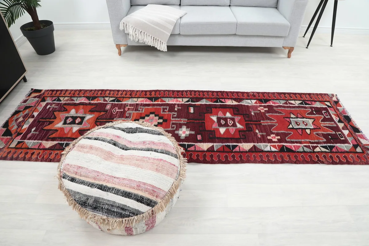 Full view of the runner rug in the room, focusing on its length and design next to a sofa